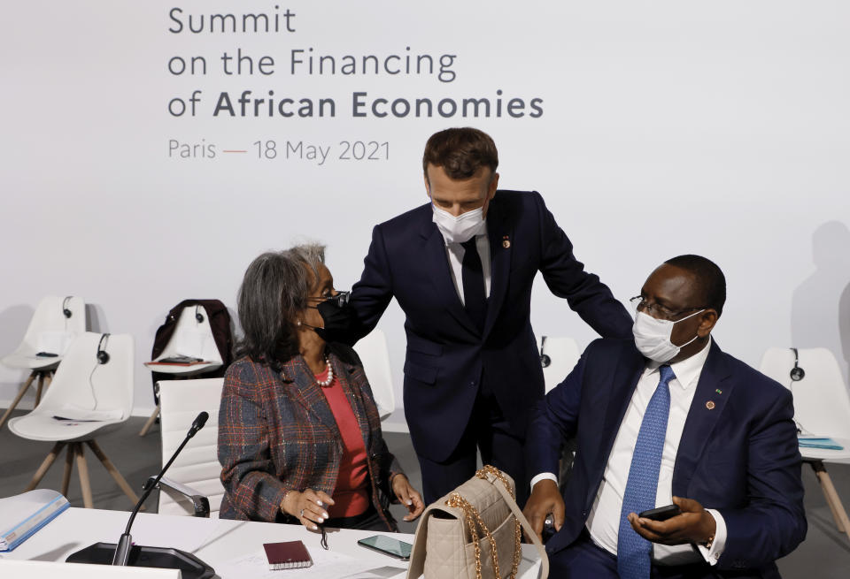 rench President Emmanuel Macron, center, salutes Ethiopia's President Sahle-Work Zewde, left, and Senegal's President Macky Sall at the Summit on the Financing of African Economies Tuesday, May 18, 2021 in Paris. More than twenty heads of state and government from Africa are holding talks in Paris with heads of international organizations on how to revive the economy of the continent, deeply impacted by the consequences of the COVID-19 pandemic. (Photo by Ludovic Marin, Pool via AP)