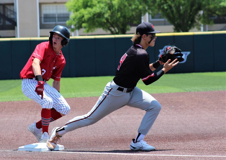 Anson's Stryker Dillard (3) points to the bag indicating he's safe as New Home third baseman Logan Addison takes the throw in Game 2 of their Region I-2A semifinal series. The Tigers won the game 4-2 to force Game 3.