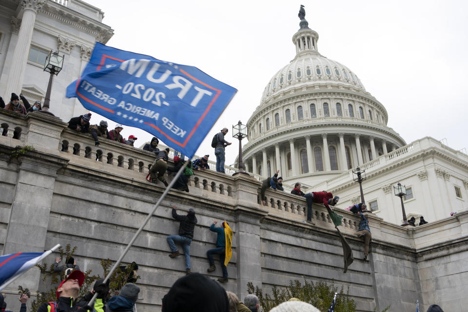 FILE - In this Jan. 6, 2021 file photo, violent insurrectionists loyal to President Donald Trump scale the west wall of the the U.S. Capitol in Washington. (AP Photo/Jose Luis Magana, File)