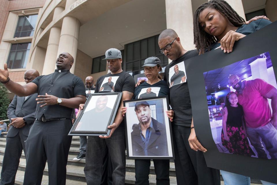 From the left, Rev. A'Kim K. Beecham offers prayer with brother Lamar, mother Rose, brother Dwaye and sister April Palmer outside the York County Judicial Center Monday. Family members and supporters of Everett Palmer Jr. who died while in custody at York County Prison demanded answers about the circumstances of his death, stating that they do not believe he took his own life.