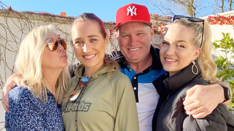 Dean Jones is seen here posing for a photo with his wife and two daughters.