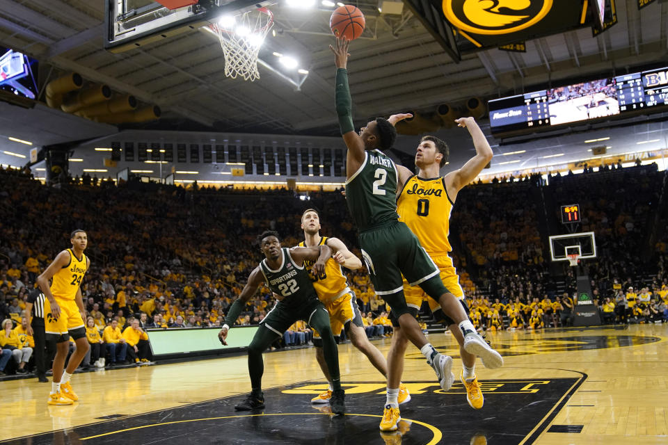 Michigan State guard Tyson Walker (2) drives to the basket past Iowa forward Filip Rebraca (0) during the first half of an NCAA college basketball game, Saturday, Feb. 25, 2023, in Iowa City, Iowa. (AP Photo/Charlie Neibergall)