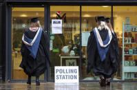 Students from the University of Reading arrive to vote in the general election, in Reading, England, Thursday Dec. 12, 2019. The U.K. is voting Thursday for they want to resolve the stalemate over Brexit, in a parliamentary election widely seen as one of the most decisive in modern times.(Steve Parsons/PA via AP)