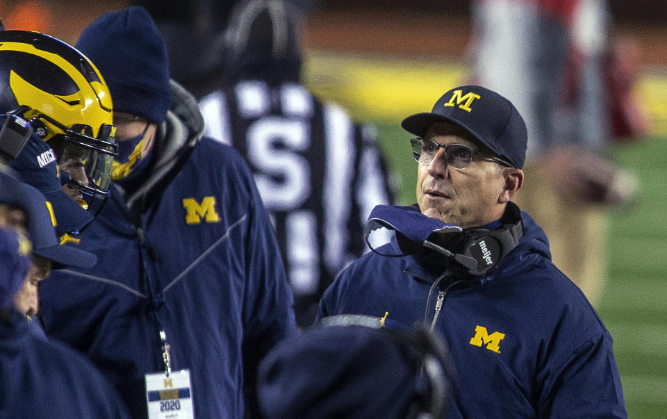 Michigan coach Jim Harbaugh stands on the sideline during the first quarter of the team's NCAA college football game against Wisconsin in Ann Arbor, Mich., Saturday, Nov. 14, 2020. (AP Photo/Tony Ding)