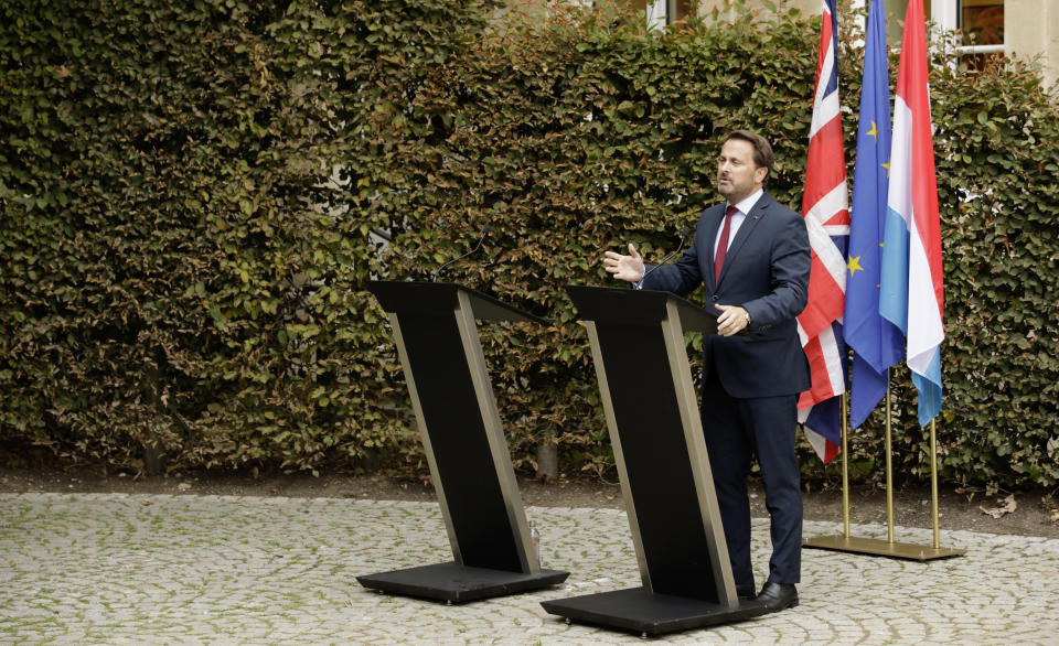 Luxembourg's Prime Minister Xavier Bettel, right, addresses a media conference next to an empty lectern intended for British Prime Minister Boris Johnson after a meeting at the prime ministers office in Luxembourg, Monday, Sept. 16, 2019. (AP Photo/Olivier Matthys)