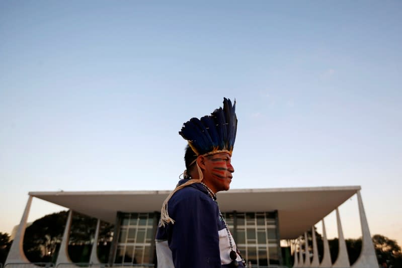 FILE PHOTO: An Indigenous man from the Guarani Kaiowa tribe attends a protest to defend indigenous land, outside Brazil's Supreme Federal Court in Brasilia