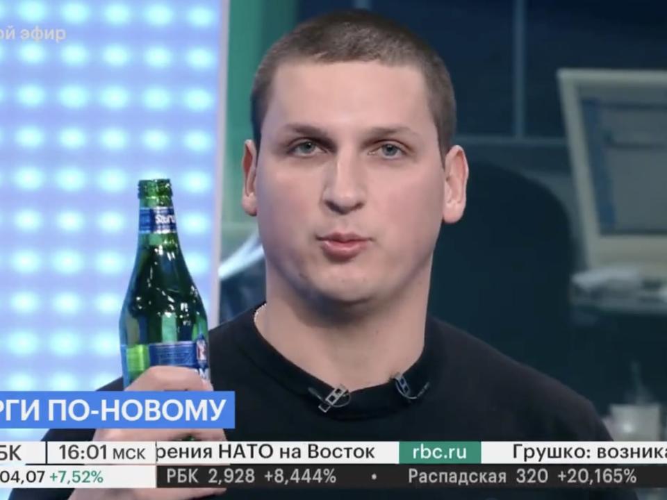 Alexander Butmanov holds up soda on Russian TV.