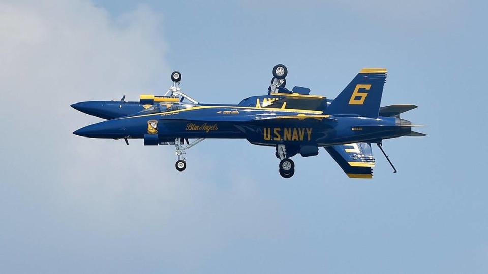 Two pilots from the United States Navy Blue Angels fly very close to make a mirror image on the second and final day of the 2021 Kansas City Airshow at the New Century AirCenter in New Century, Kansas, Sunday, July 4, 2021.