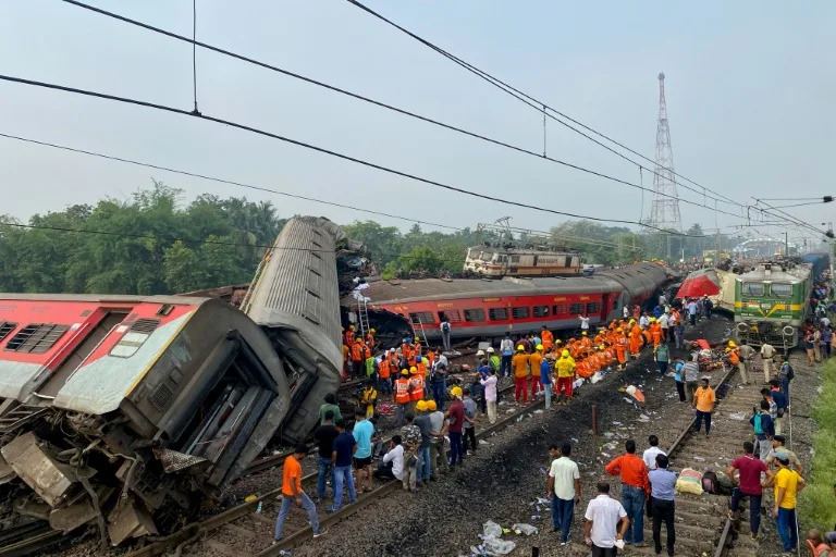 Rescue workers search for survivors at the accident site of a three-train collision near Balasore, India