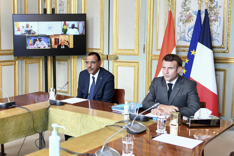 French President Emmanuel Macron and Niger's President Mohamed Bazoum, left, attend a video summit with leaders of G5 Sahel countries after France's decision last month to reduce French anti-terror troops in West Africa, at the Elysee presidential Palace in Paris, Friday July 9, 2021. (Stephane de Sakutin, Pool photo via AP)