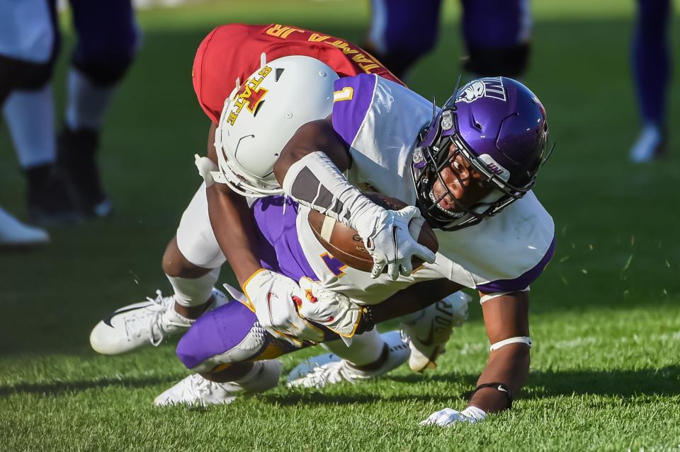 Northern Iowa Panthers wide receiver Deion McShane (1) stretches for extra yardage against Iowa State Cyclones defensive back T.J. Tampa (25) in the second half at Jack Trice Stadium.