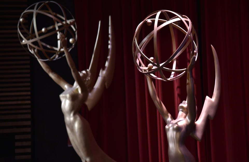 FILE - In this July 12, 2018, file photo, Emmy statues appear on stage at the 70th Primetime Emmy Nominations Announcements at the Television Academy's Saban Media Center, in Los Angeles. The Emmy Awards, the first big Hollywood ceremony to attempt a live -- but socially distanced -- broadcast amid the pandemic, will be held on Sunday, Sept. 20, 2020, and producers are promising a live TV experience with 100 cameras in the homes of nominees, and all the chaos that could entail. (Photo by Chris Pizzello/Invision/AP, File)