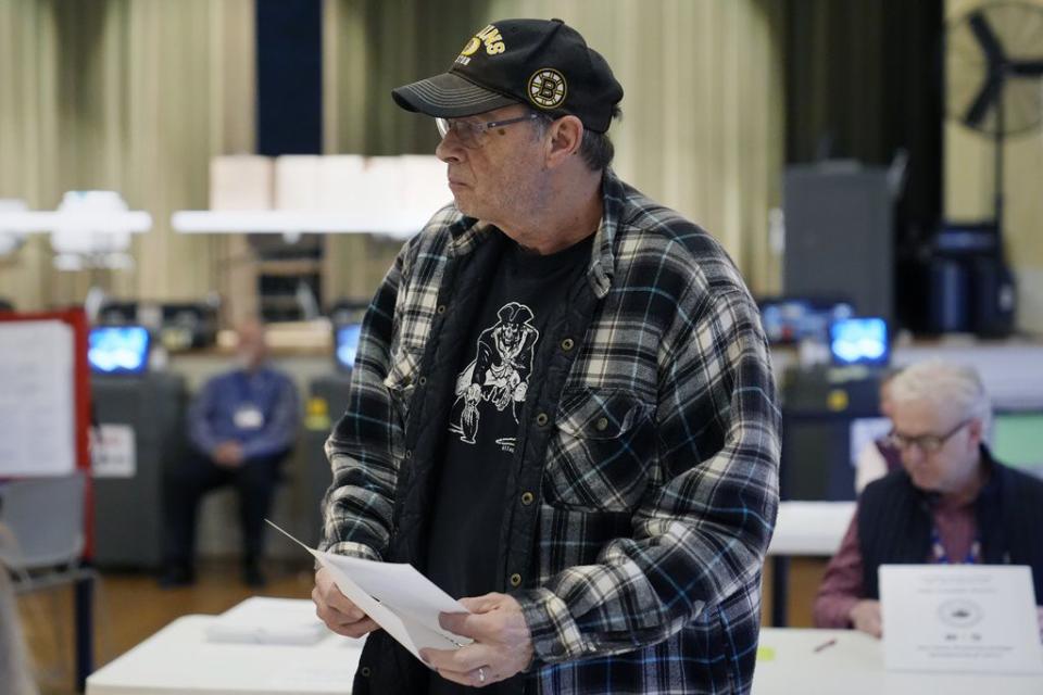 A voter picks up his ballot after checking in at the polling station in Kennebunk, Maine, Tuesday, March 5, 2024. Super Tuesday elections are being held in 16 states and one territory. Hundreds of delegates are at stake, the biggest haul for either party on a single day.   (AP Photo/Michael Dwyer)