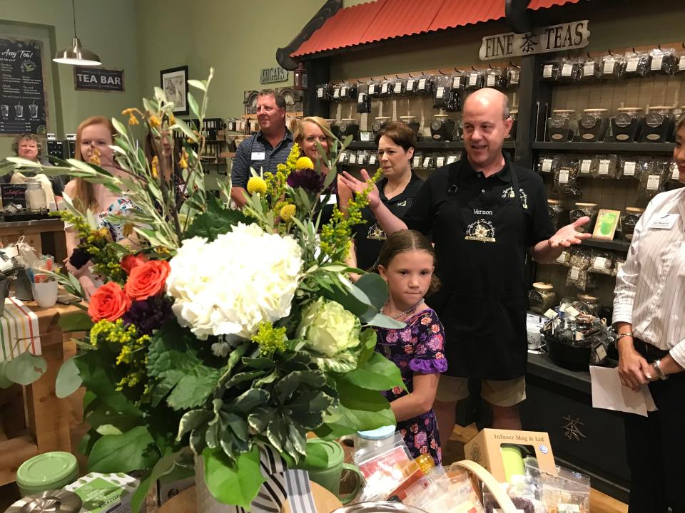 The Spice & Tea Exchange franchise owners Tami (middle right) and Vernon Brown (foreground) welcomed Sioux Falls business leaders and others to their store Friday for a ribbon-cutting event. The store is hosting a grand opening event this weekend.