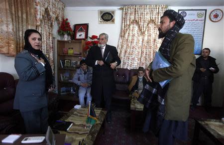 Colonel Jamila Bayaaz (L) talks with Afghans at her office in Kabul January 15, 2014. REUTERS/Mohammad Ismail