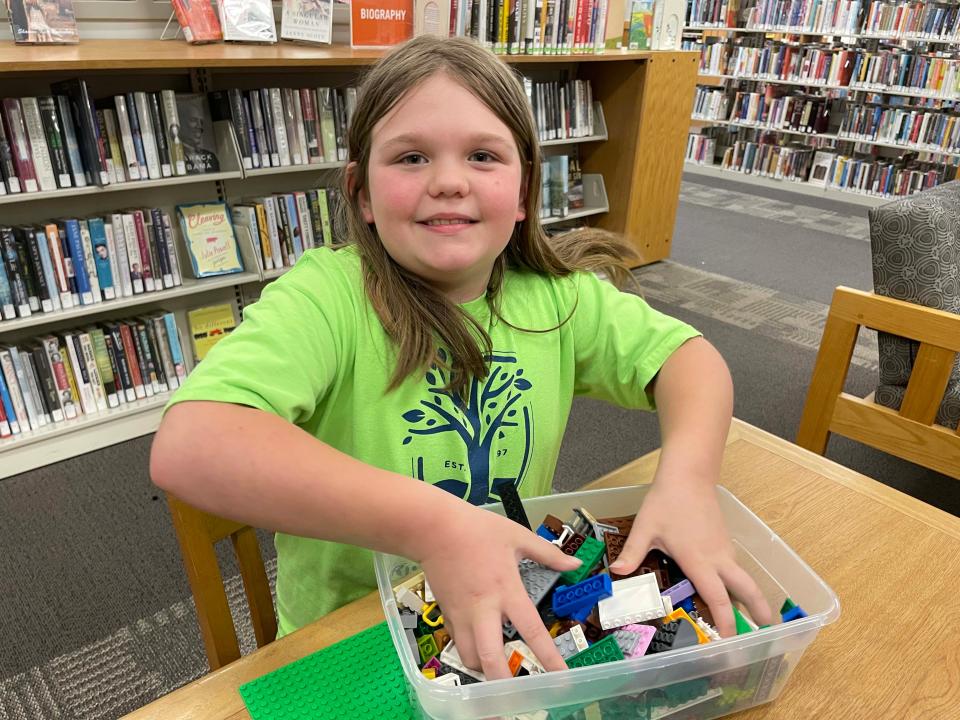 Millie Jerviss, 9, digs deep into her bin of LEGOs hoping for inspiration at the monthly LEGO Club at Karns Branch Library Saturday, May 21, 2022.