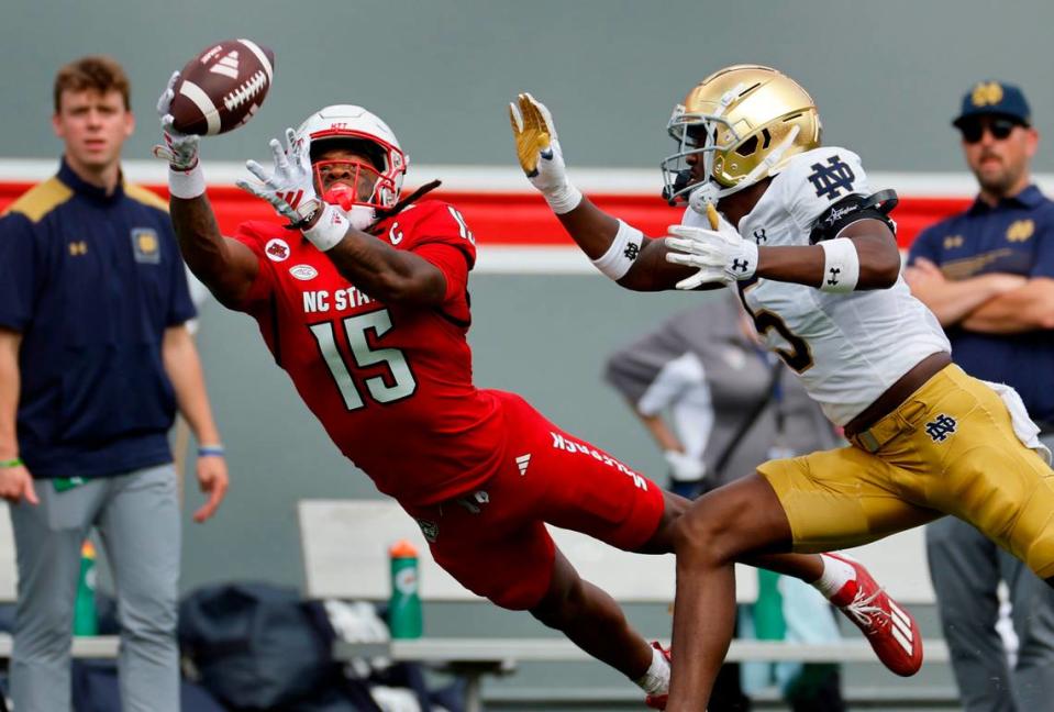 N.C. State wide receiver Keyon Lesane (15) pulls in the 38-yard reception with one hand as Notre Dame cornerback Cam Hart (5) defends during the second half of Notre Dame’s 45-24 victory over N.C. State at Carter-Finley Stadium in Raleigh, N.C., Saturday, Sept. 9, 2023.