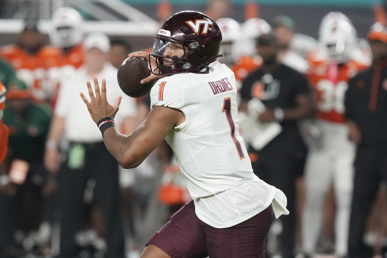 Virginia Tech quarterback Kyron Drones (1) aims a pass during the first half of an NCAA college football game against Miami, Friday, Sept. 27, 2024, in Miami Gardens, Fla. (AP Photo/Marta Lavandier)