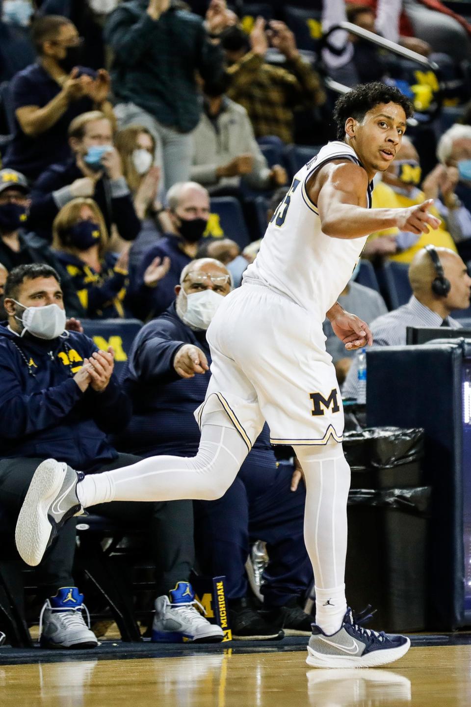 Michigan guard Eli Brooks celebrates a 3-point basket against Iowa during the first half at the Crisler Center in Ann Arbor on Thursday, March 3, 2022.