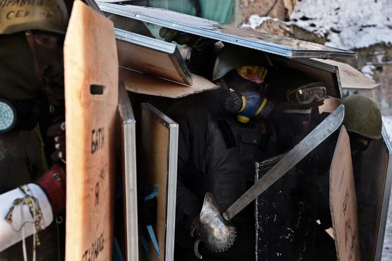 Opposition protesters train with shields and a sword in the center of Kiev on January 30, 2014