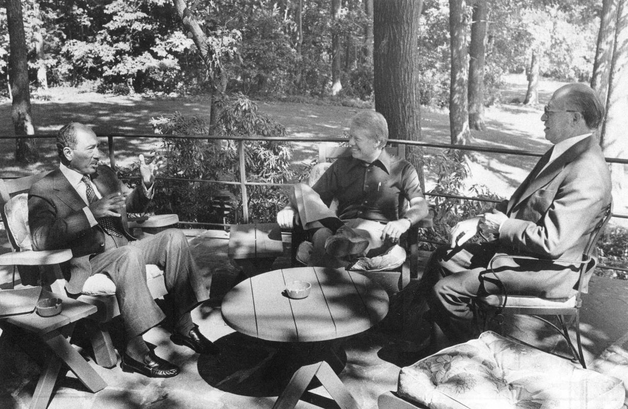 The principals in the Middle East Summit, from left, Egyptian President Anwar Sadat, U.S. President Jimmy Carter, and Israeli Prime Minister Menachem Begin, meeting for the first time at Camp David, Md. on Sept. 6, 1978. (The White House via AP)