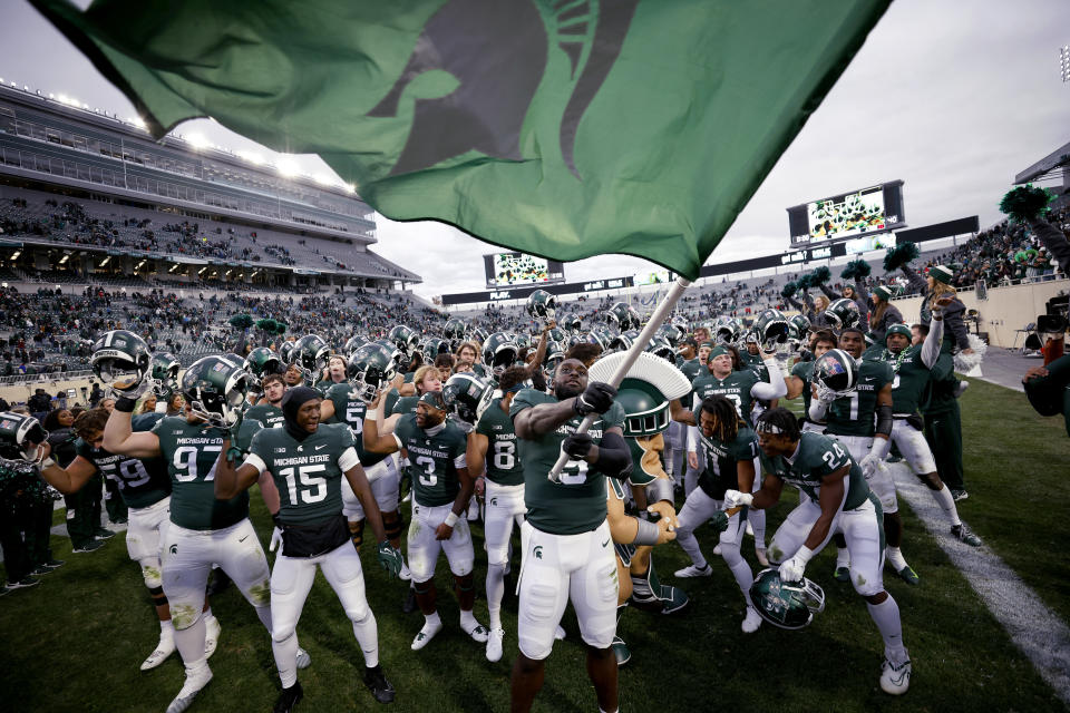 Michigan State players celebrate after defeating Rutgers in an NCAA college football game, Saturday, Nov. 12, 2022, in East Lansing, Mich. Michigan State won 27-21. (AP Photo/Al Goldis)