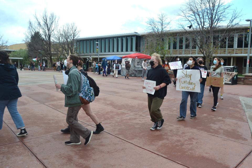 Pro-Palestinian protesters march in a circle on the 'free speech plaza' outside Colorado State University's Lory Student Center on Wednesday, May 1, 2024.