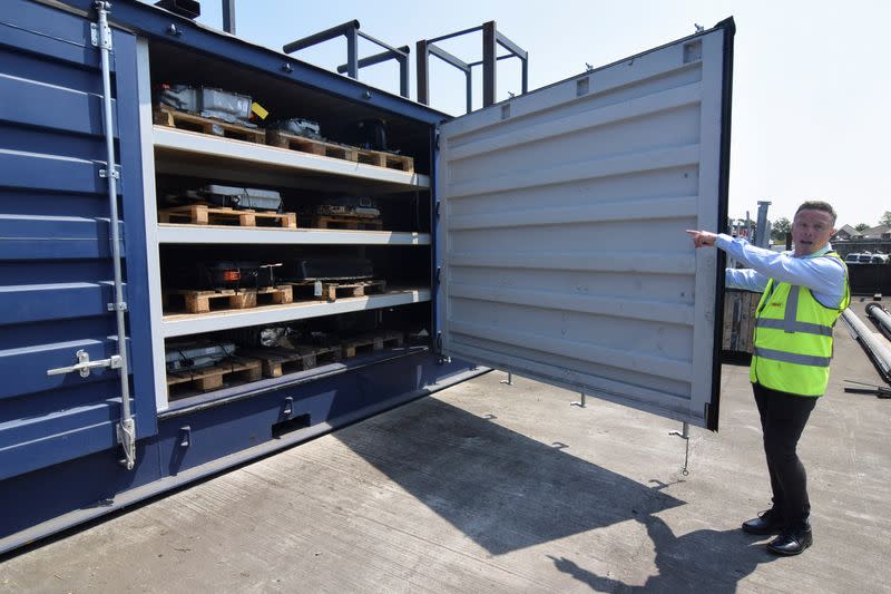 FILE PHOTO: CEO of Charles Trent Ltd opens up a container for batteries salvaged from written-off electric vehicles and hybrids in Poole