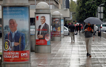 A man walks past election posters ahead of the parliamentary elections in Podgorica, Montenegro October 6, 2016. REUTERS/Stevo Vasiljevic