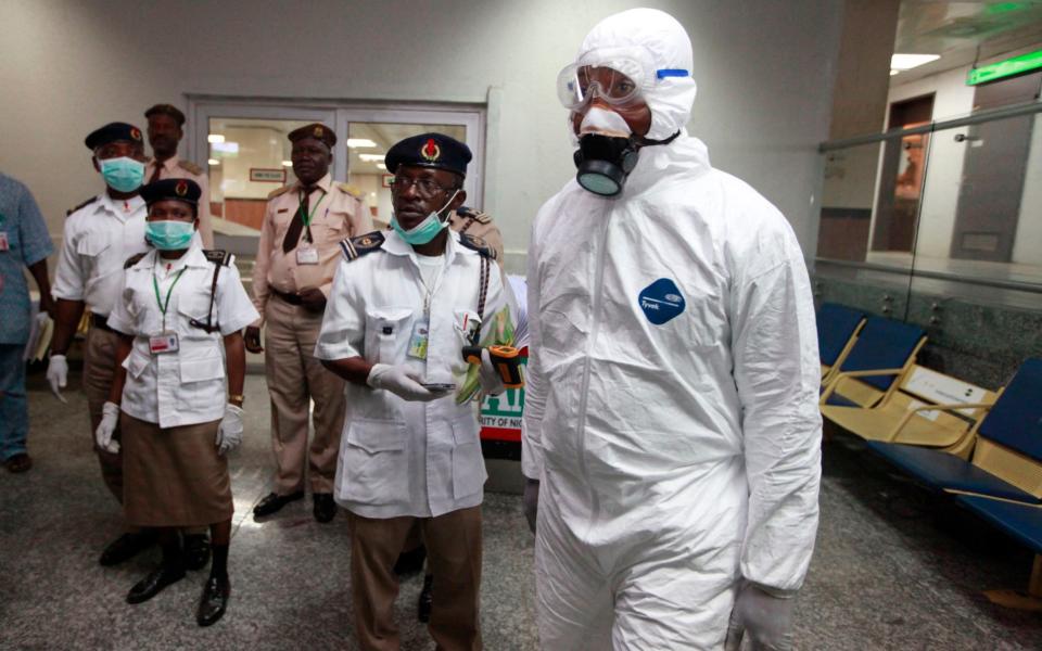 Nigerian health officials wait to screen passengers at the airport in Lagos in 2014 when the country faced an Ebola crisis - AP