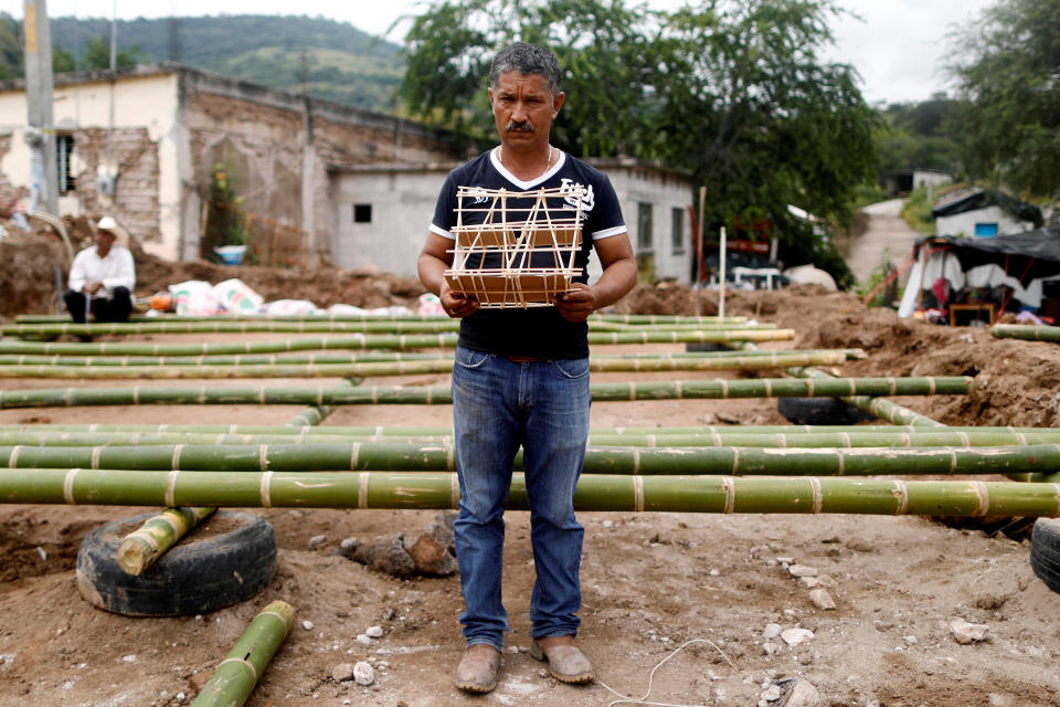 <p>Hector Guzman, 48, peasant and representative of the Municipal President in San Jose Platanar, holds the model of a new house for his father as he poses for a portrait after an earthquake in San Jose Platanar, at the epicentre zone, Mexico, September 28, 2017. Guzman is building his father a temporary house with bamboo reeds after it was badly damaged. (Photo: Edgard Garrido/Reuters) </p>