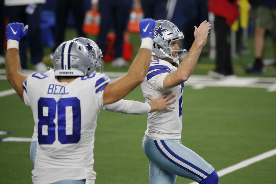 Dallas Cowboys tight end Blake Bell (80) and Greg Zuerlein (2), right, celebrate Zuerlein's game winning field goal in the second half of an NFL football game against the New York Giants in Arlington, Texas, Sunday, Oct. 11, 2020. (AP Photo/Michael Ainsworth)