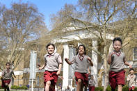 Pupils from Hill House School in London, play on the grass in front of the now Saatchi Gallery, where Britain's King Charles III played sport as a pupil, Thursday, April 20, 2023. King Charles III hasn’t even been crowned yet, but his name is already etched on the walls of Hill House School in London. A wooden slab just inside the front door records Nov. 7, 1956, as the day the future king enrolled at Hill House alongside other notable dates in the school’s 72-year history. (AP Photo/Kirsty Wigglesworth)