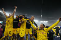 Borussia Dortmund players celebrate at the end of the Champions League semifinal second leg soccer match between Paris Saint-Germain and Borussia Dortmund at the Parc des Princes stadium in Paris, France, Tuesday, May 7, 2024. (AP Photo/Frank Augstein)