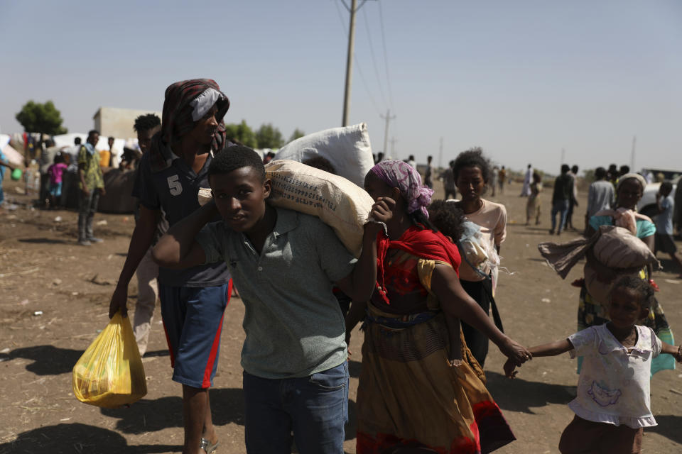 Refugees from the Tigray region of Ethiopia arrive at Hamdayet, Sudan on Saturday, Nov. 14, 2020. Many are waiting to register at the UNCHR center. Ethiopia’s defiant Tigray regional government has fired rockets at two airports in the neighboring Amhara region as a deadly conflict threatens to spread into other parts of Africa’s second-most populous country. (AP Photo/Marwan Ali)