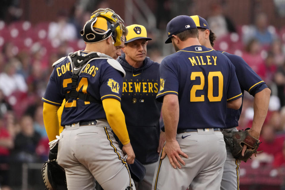 Milwaukee Brewers manager Craig Counsell, center, and catcher William Contreras (24) talk with starting pitcher Wade Miley (20) as Miley is removed from a baseball game against the St. Louis Cardinals during the second inning Tuesday, May 16, 2023, in St. Louis. (AP Photo/Jeff Roberson)