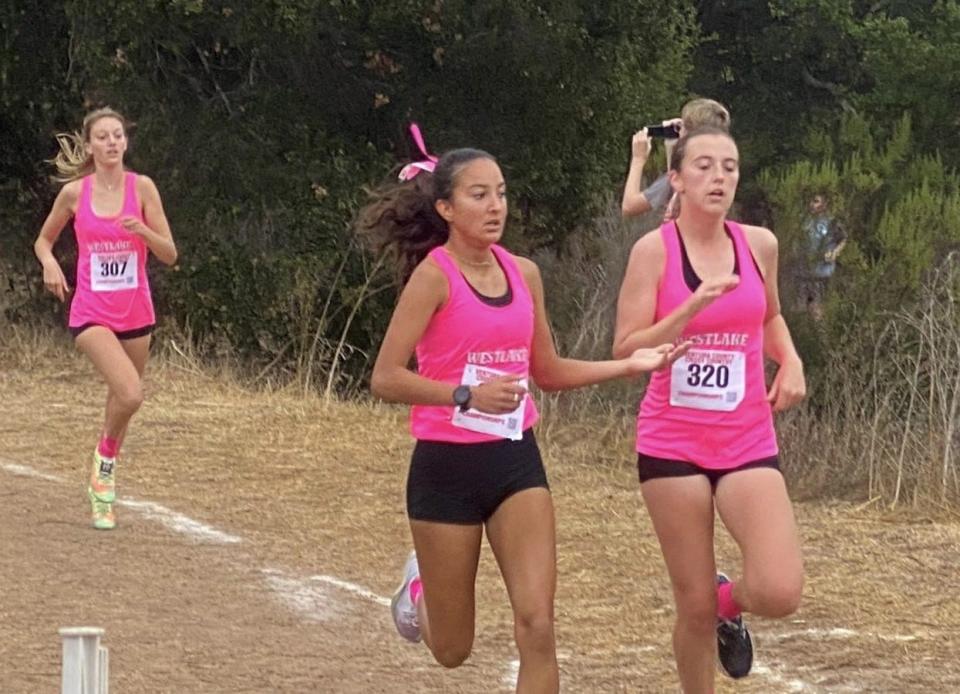 Westlake's Alexa Piñon and Kalista Traversa (right) run side by side with Laura Castagna just behind during the Ventura County Cross Country Championships on Saturday at Lake Casitas. Westlake won the girls team title.