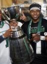 The Saskatchewan Roughriders Kory Sheets holds the Grey Cup in the dressing room after the Roughriders defeated the Hamilton Tiger-Cats in the CFL's 101st Grey Cup championship football game in Regina, Saskatchewan November 24, 2013. REUTERS/Mark Blinch (CANADA - Tags: SPORT FOOTBALL)