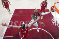 United States' Damian Lillard (6) shoots over Iran's Mohammadsina Vahedi (3) during a men's basketball preliminary round game at the 2020 Summer Olympics, Wednesday, July 28, 2021, in Saitama, Japan. (Charlie Neibergall/Pool Photo via AP)