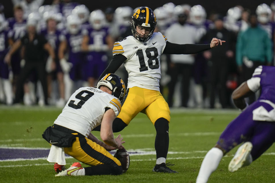 Iowa place-kicker Drew Stevens (18) boots a winning 52-yard field goal during the second half of an NCAA college football game against Northwestern, Saturday, Nov. 4, 2023, at Wrigley Field in Chicago. (AP Photo/Erin Hooley)
