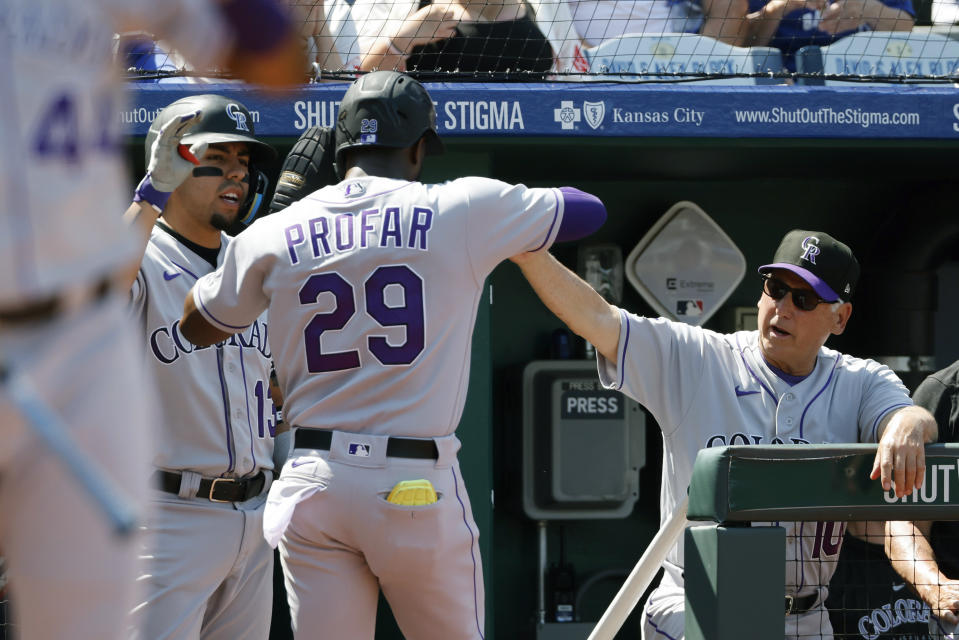 Colorado Rockies manager Bud Black, right, and Alan Trejo, left, congratulate Jurickson Profar (29) as he heads into the dugout after scoring off a Randal Grichuk single during the first inning of a baseball game against the Kansas City Royals in Kansas City, Mo., Saturday, June 3, 2023. (AP Photo/Colin E. Braley)