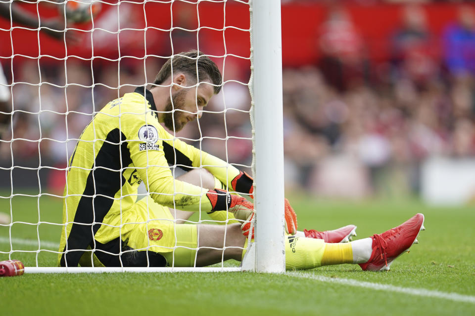 Manchester United's goalkeeper David de Gea reacts after Aston Villa's Kortney Hause scored his side's opening goal during the English Premier League soccer match between Manchester United and Aston Villa at the Old Trafford stadium in Manchester, England, Saturday, Sept 25, 2021. (AP Photo/Jon Super)