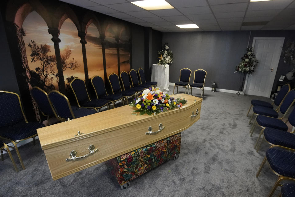 SHIPLEY, WEST YORKSHIRE - MAY 26: The casket of Covid-19 victim Dennis Clapham, aged 62, is prepared to be transported to Nab Wood Crematorium on May 26, 2020 in Shipley, West Yorkshire. His sister Ann Clapham cared for him whilst he suffered from ill health at home. He later moved into a care home where he could get the extra help he needed. Dennis and Ann had planned his funeral arrangements two years ago. Guardian Funerals is a family-owned funeral service in Shipley, West Yorkshire, that, like many such providers, has confronted the unique challenges presented by Covid-19. There are new rules for how the deceased are handled and how family members can commemorate the deceased prior to burial or cremation -- restrictions that can make a tough situation even tougher. The home's director, Alison Barrington, is a third-generation undertaker who believes that the pastoral element of being a funeral director is as important to bereaved families as the professional undertaker services that they provide. Alison, who works alongside her husband Daniel and a small team, believes that people are failing to associate the graphs and figures describing the Covid-19 death toll with the human victims of the crisis and the devastating effect it has had on families across the world. (Photo by Christopher Furlong/Getty Images)