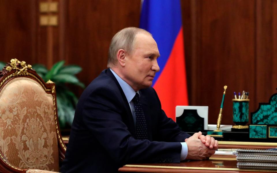 Russian President Vladimir Putin listens during a meeting in the Kremlin in Moscow on Friday - Kremlin Pool Photo via AP