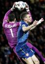 AS Monaco's goalkeeper Danijel Subasic (L) grabs the ball as he jumps against Arsenal's Laurent Koscielny during their Champions League round of 16 second leg soccer match at the Louis II Stadium in Monaco, March 17, 2015. REUTERS/Eric Gaillard (MONACO - Tags: SPORT SOCCER)