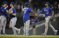 Toronto Blue Jays including Vladimir Guerrero Jr. (27) celebrates at the end of a baseball game against the Atlanta Braves Tuesday, May 11, 2021, in Atlanta. (AP Photo/Ben Margot)