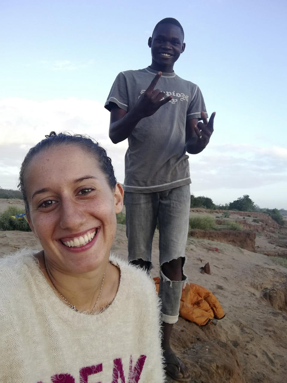 FILE - In this August 2018 file photo, Italian volunteer Silvia Costanza Romano, left, poses with local resident Ronald Kazungu Ngala, 19, in the village of Chakama, in coastal Kilifi county, Kenya. Italian Premier Giuseppe Conte has announced that an Italian aid worker kidnapped in late 2018 while she was working in Kenya has been freed. Conte tweeted Saturday: “Silvia Romano has been freed. Thanks to the men and women of the foreign intelligence services. Silvia, we’re waiting for you in Italy!” (AP Photo, File)