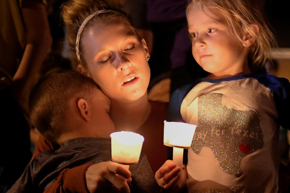 A woman and her children take part in a vigil for victims of a mass shooting in Sutherland Springs.&nbsp;