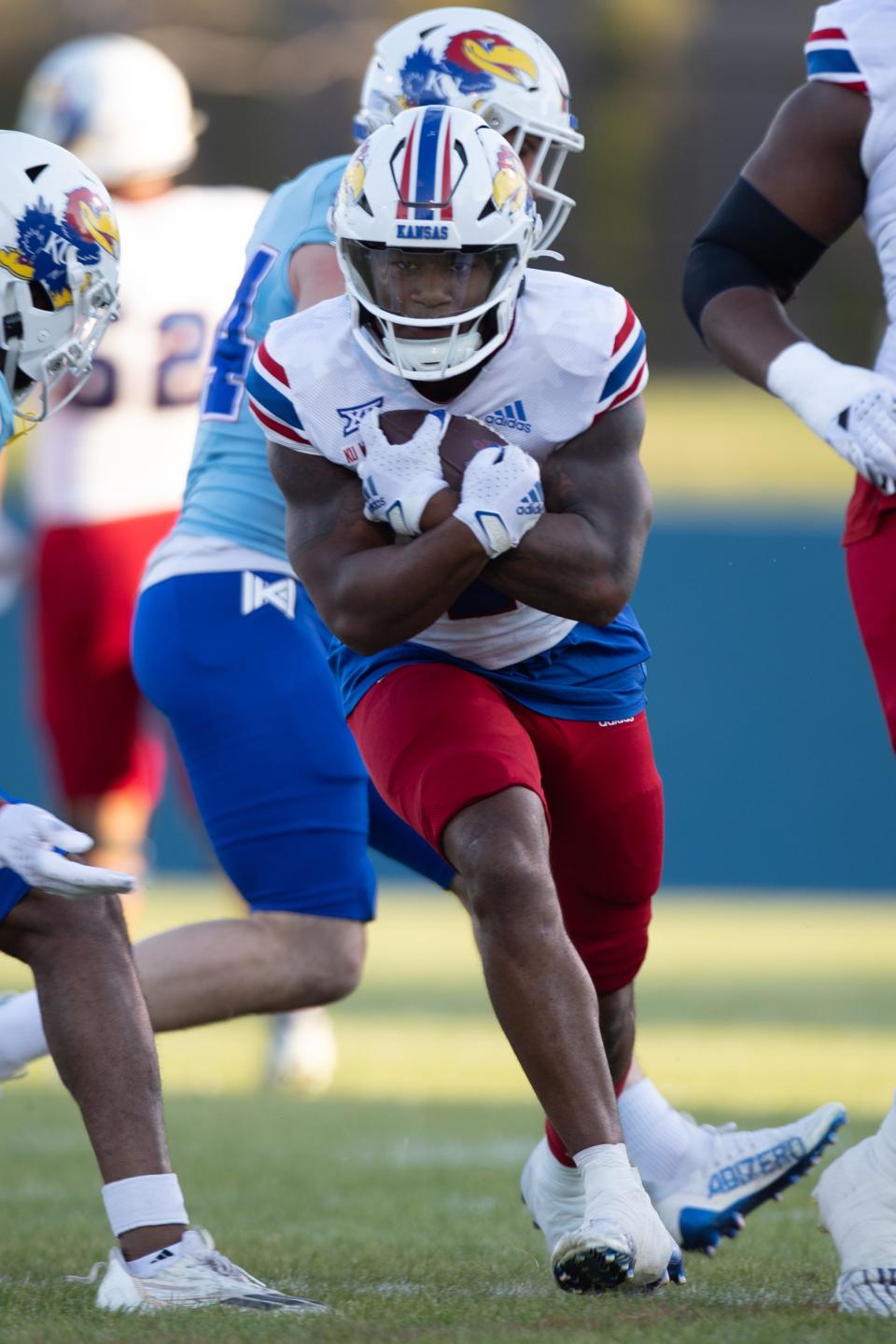 Kansas football senior running back Devin Neal (4) makes a play during Friday's spring showcase event at Rock Chalk Park in Lawrence.
