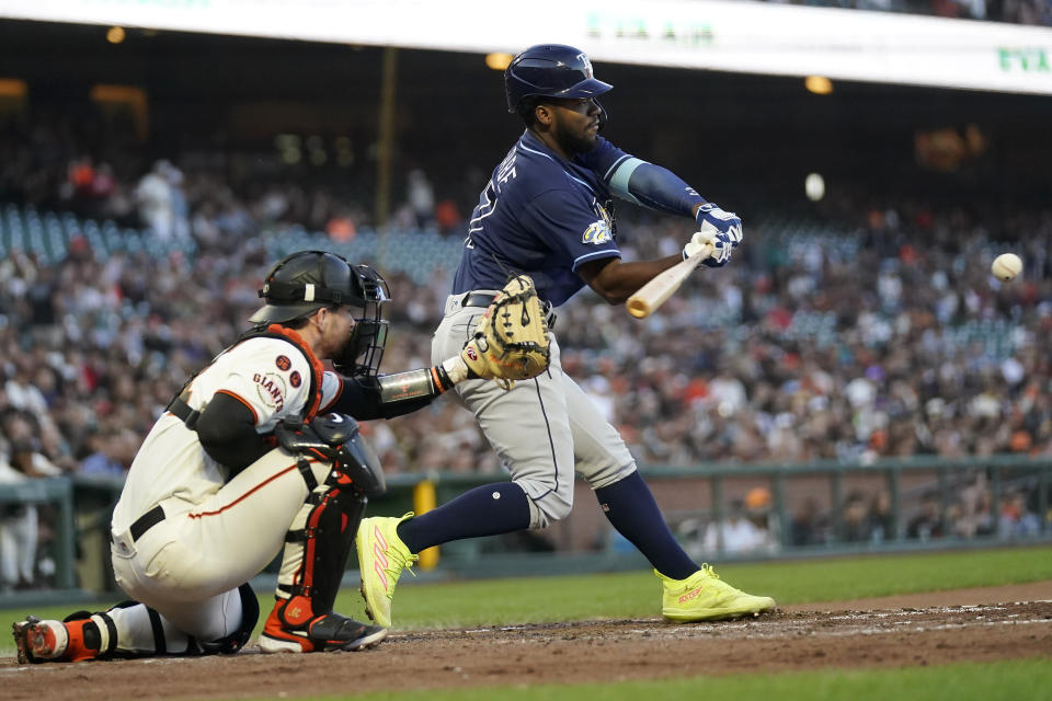 Tampa Bay Rays' Osleivis Basabe, right, hits a two-run single in front of San Francisco Giants catcher Patrick Bailey during the fourth inning of a baseball game in San Francisco, Monday, Aug. 14, 2023. (AP Photo/Jeff Chiu)